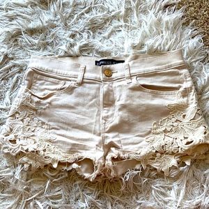 Express cream colored shorts with lace detail.